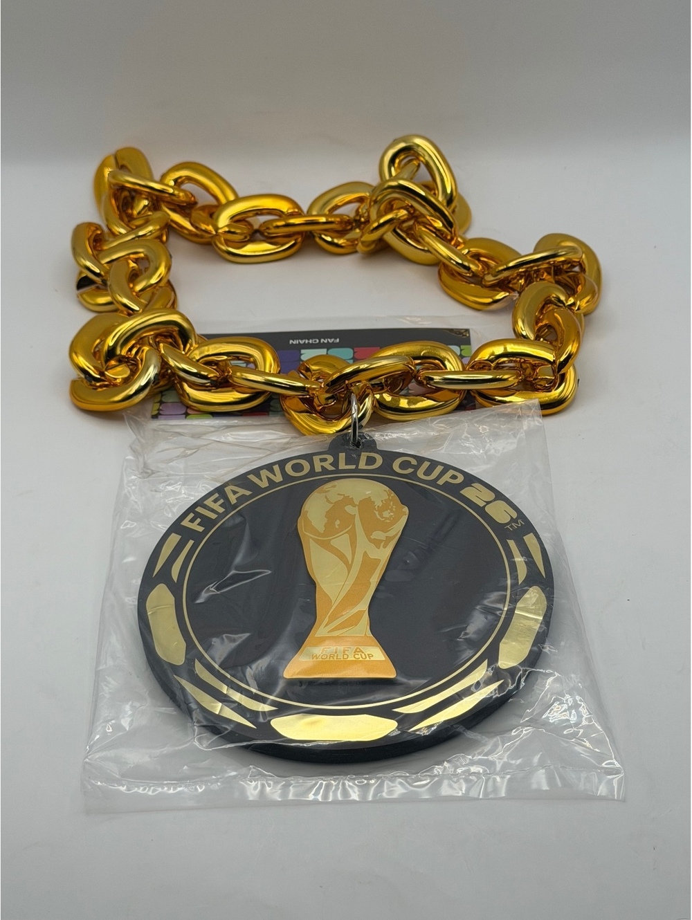 FIFA World Cup round sign with gold chain